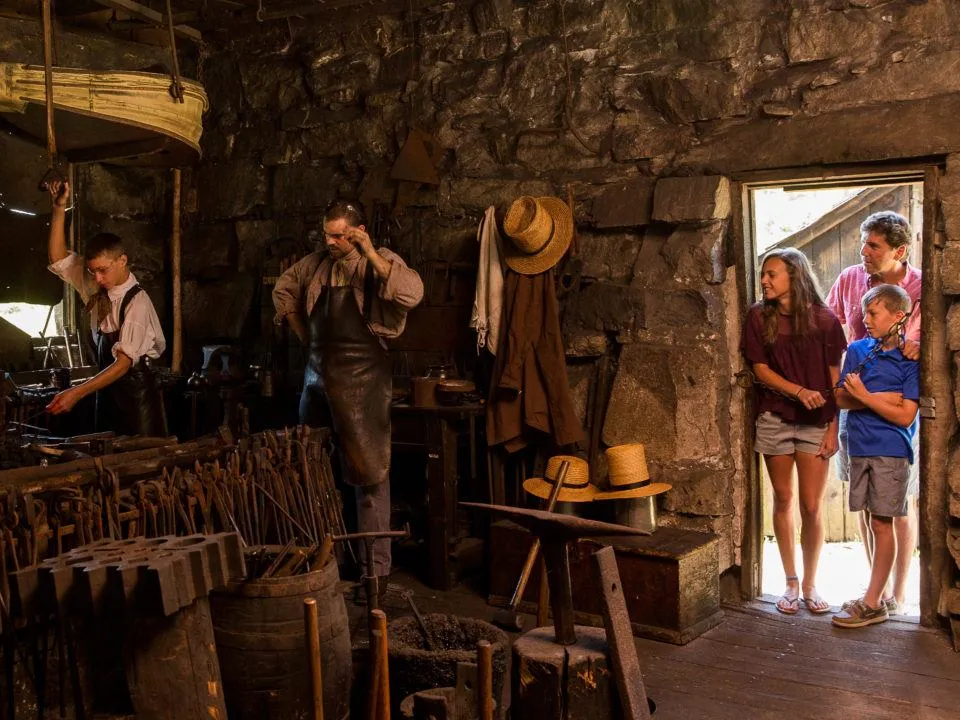 A Family watches the Blacksmiths hard at work