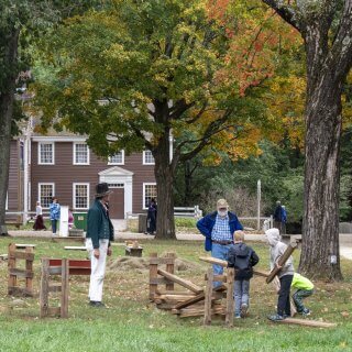 Kids building a fence