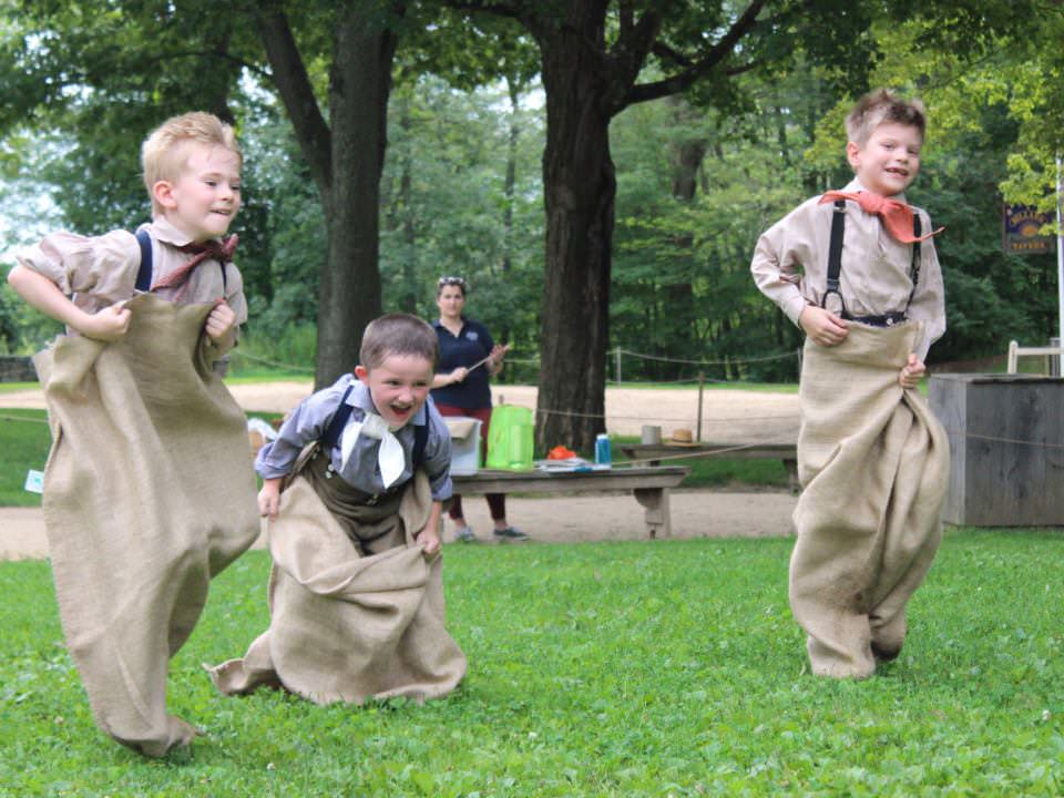 Discovery Adventures Campers playing old-fashioned games on the Village Common